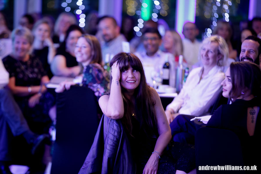 Photography of dinner reception attendee enjoying the after dinner speeker